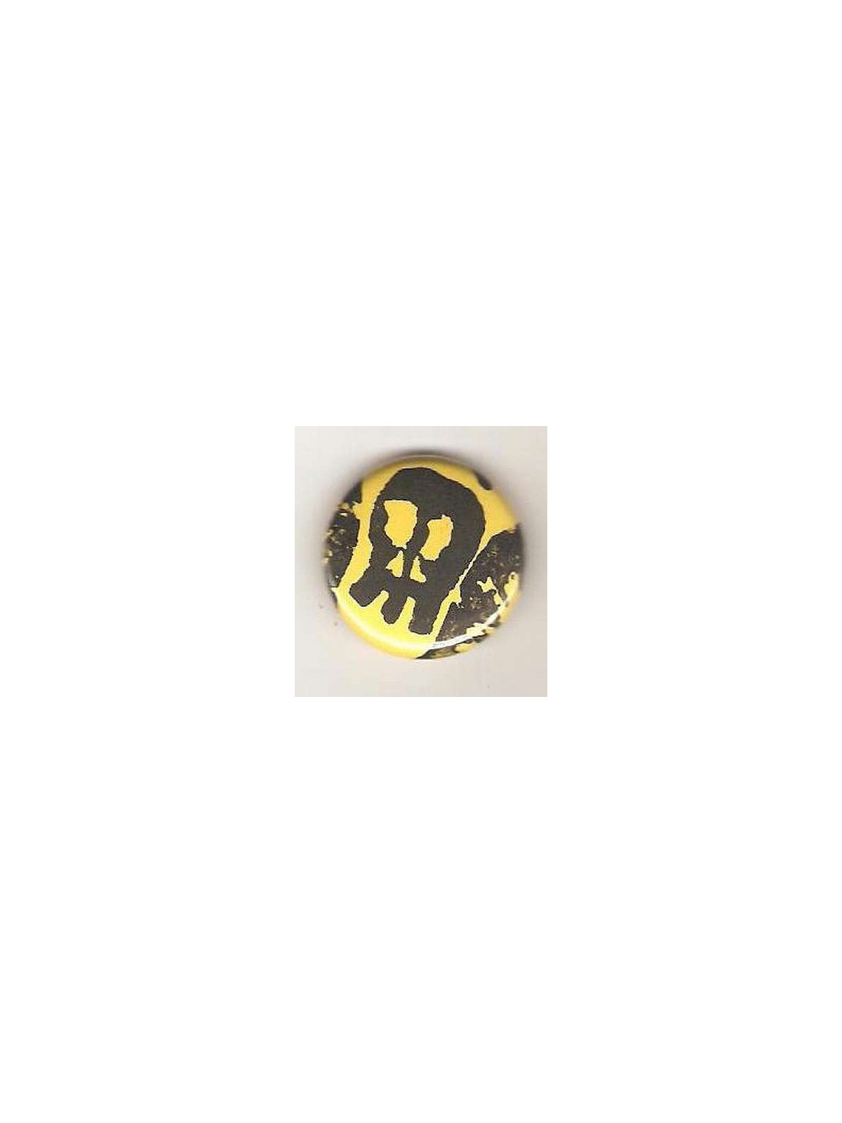 Badge jaune linogravure crâne allongé