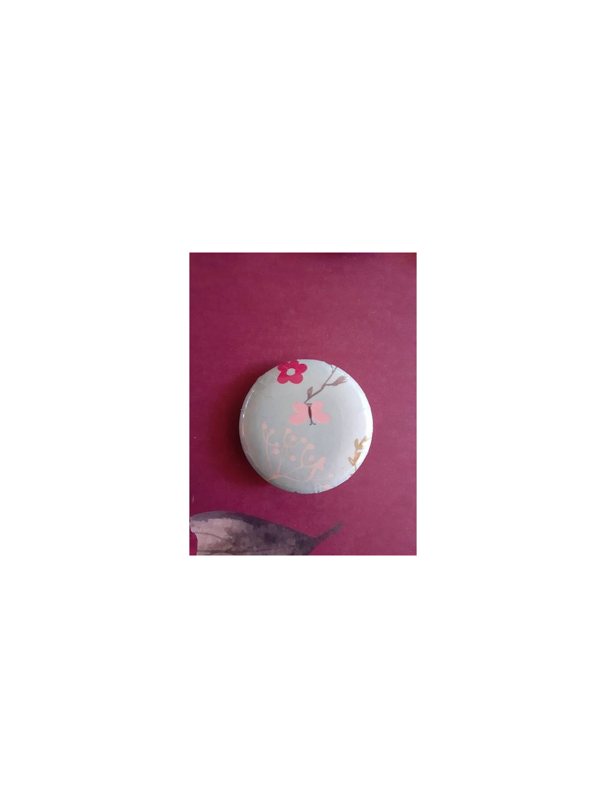 Badge papillon rose et fleur blanche sur fond bleu