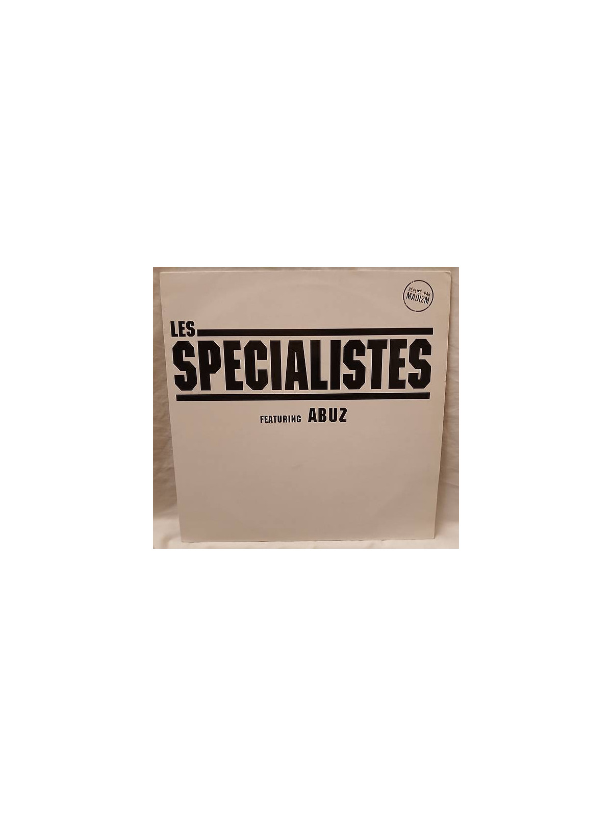 Le disque de Les spécialistes : Qui est disponible en vinyle à Ciel rouge, disquaire à Dijon