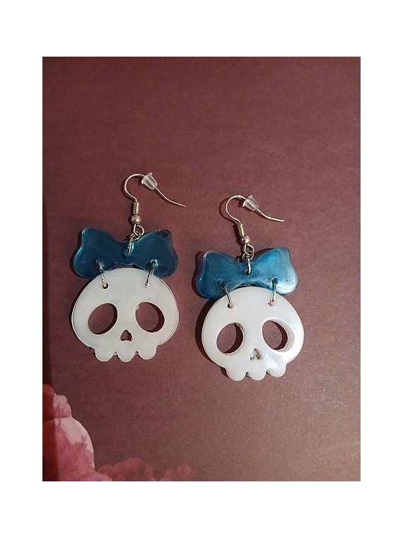 La paire de boucle d'oreilles  cranes blancs et noeuds en résine est disponible à Ciel rouge Dijon